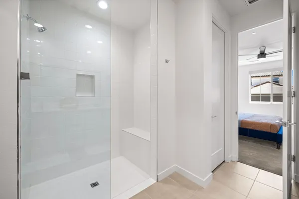 a bathroom with a double vanity sink toilet and shower