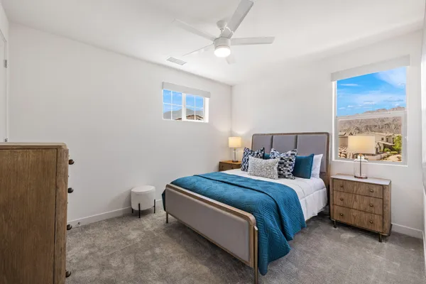a living room with furniture a rug and kitchen view