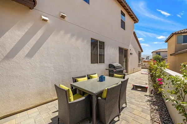 a view of a patio with dining table and chairs with wooden floor