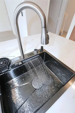 a kitchen with granite countertop a stove a sink and a microwave