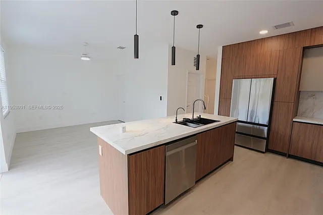 a kitchen with a sink a refrigerator and a stove