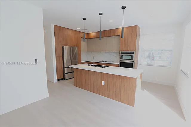 a kitchen with stainless steel appliances a refrigerator and a stove