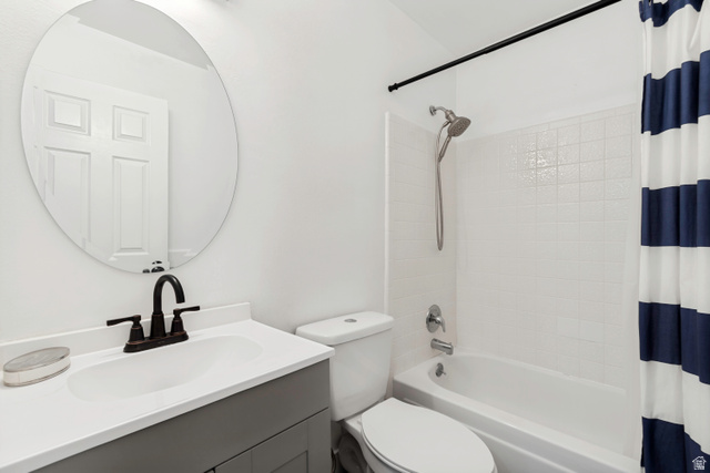 332 East Magellan Lane Elk Ridge, UT 84651 - Photo 18 of 24 Bathroom featuring a vanity with an integrated sink, dark bronze faucet, and a circular mirror