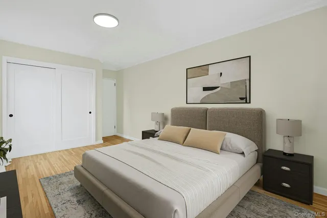 a bedroom with a bed and a night stand