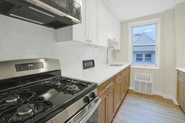 a kitchen with stainless steel appliances granite countertop a stove and a sink