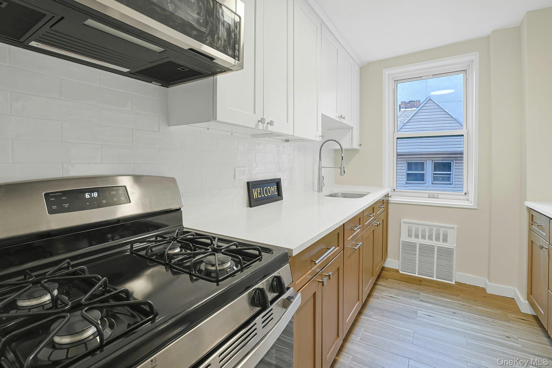 3363 Sedgwick Avenue, Unit 4D Bronx, NY 10463 - Photo 6 of 23 a kitchen with stainless steel appliances granite countertop a stove and a sink