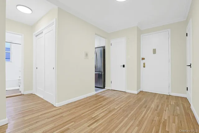 a view of a room with wooden floor and white doors