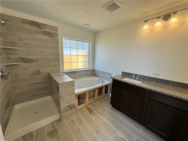 an empty room with a window and a ceiling fan