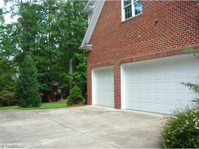4006 Rockingham Road South Greensboro, NC 27407 - Photo 13 of 16 Other. Side yard view of the 3 car garage and extra parking spaces - lovely planting throughout the yard!!