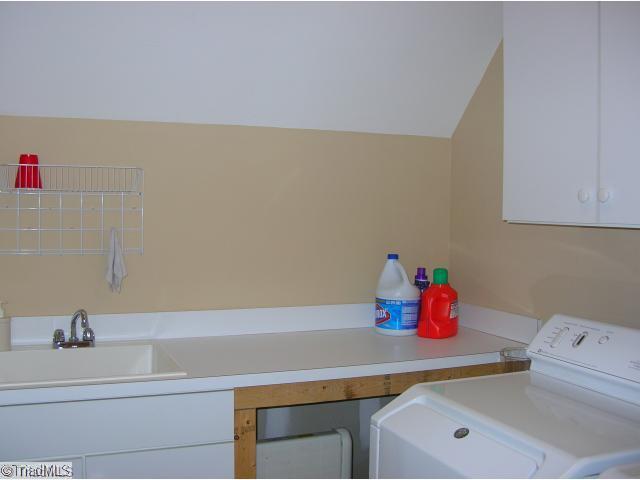 4006 Rockingham Road South Greensboro, NC 27407 - Photo 14 of 16 Laundry Room. Laundry room is upstairs. Has a sink, folding table and cabinetry.