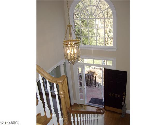 4006 Rockingham Road South Greensboro, NC 27407 - Photo 15 of 16 Entry. 2-story entry w/ palladium windows & columned opening to living room - this floorplan is truly traditional modern.