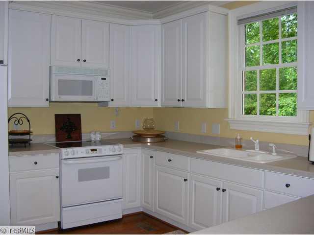 4006 Rockingham Road South Greensboro, NC 27407 - Photo 6 of 16 Kitchen. Kitchen has lots of counterspace/solid surface counters, hardwood floors- lovely view from the kitchen window!!