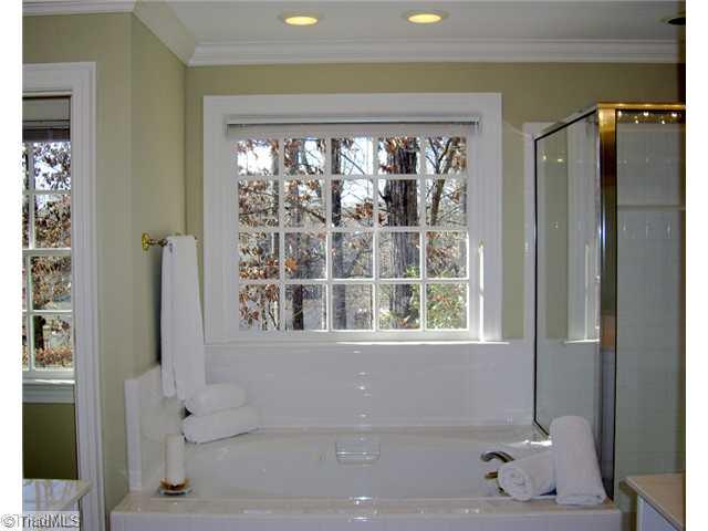 4006 Rockingham Road South Greensboro, NC 27407 - Photo 8 of 16 Master Bath/Spa. master bath has separate vanities, separate potty closet and large shower. 2 separate master closets- lots of storage in the bath and closet area!