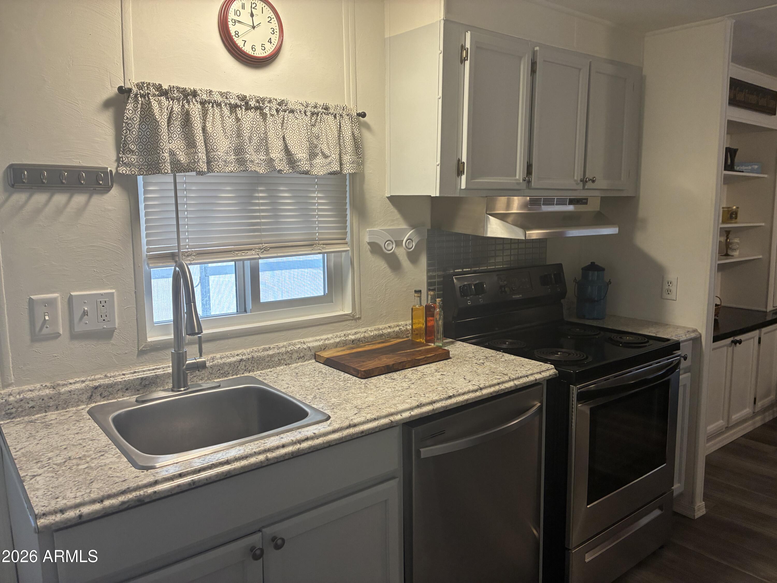 53 North Mountain Road, Unit 58 Apache Junction, AZ 85120 - Photo 15 of 39 a kitchen with a sink stove and cabinets