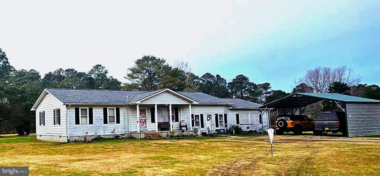 a front view of a houses with swimming pool and furniture