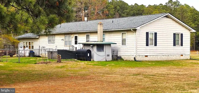 a view of a house with swimming pool and sitting area