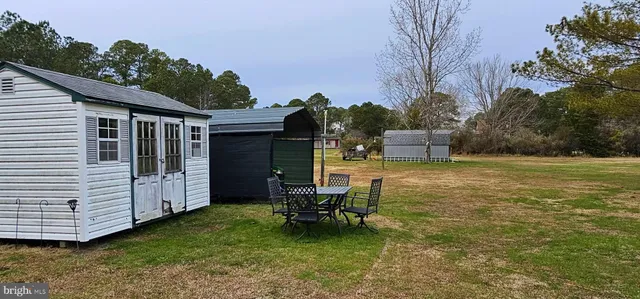 a view of a patio with table and chairs with wooden fence and plants