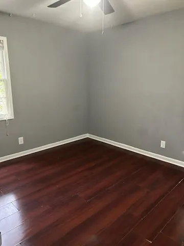 a view of a room with wooden floor and windows