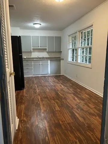 a view of a kitchen with a sink cabinet and a window
