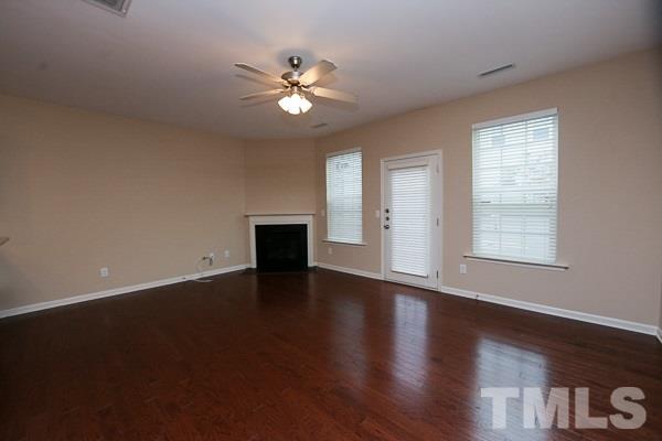 413 Starkey Street Raleigh, NC 27603 - Photo 2 of 20 a view of an empty room with wooden floor and a window