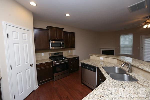 413 Starkey Street Raleigh, NC 27603 - Photo 5 of 20 a kitchen with a sink stove and refrigerator