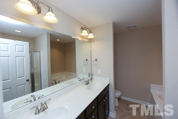 413 Starkey Street Raleigh, NC 27603 - Photo 7 of 20 a bathroom with a sink double vanity and a mirror