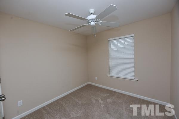 413 Starkey Street Raleigh, NC 27603 - Photo 10 of 20 an empty room with a window and a fan