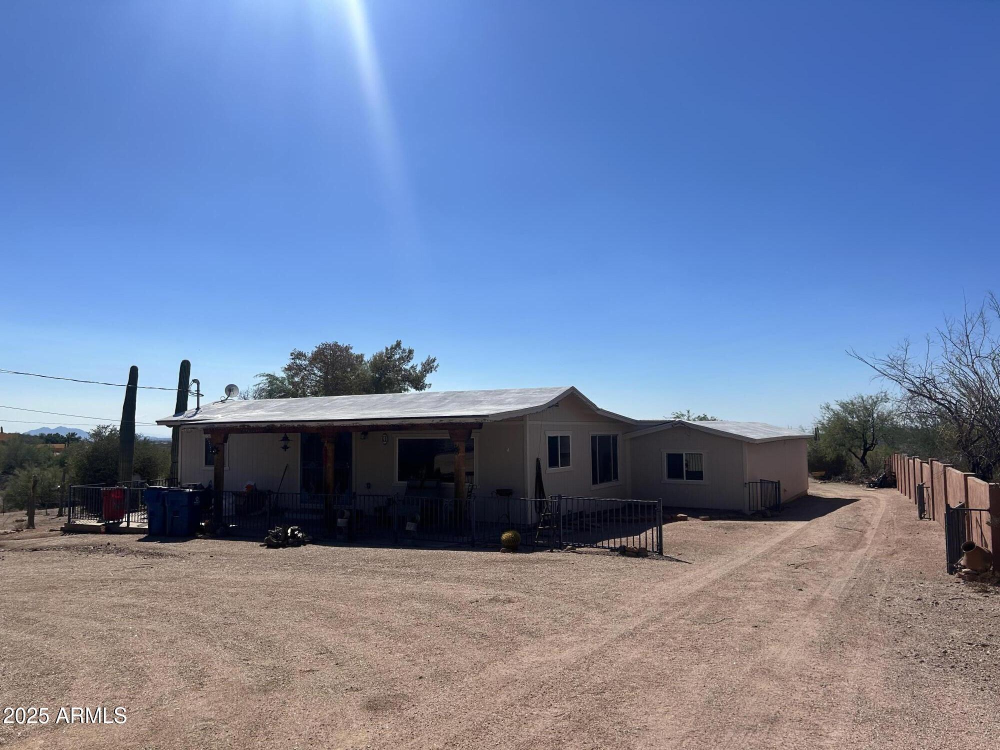 2950 North Val Vista Road Apache Junction, AZ 85119 - Photo 15 of 30 a front view of a house with a yard and garage