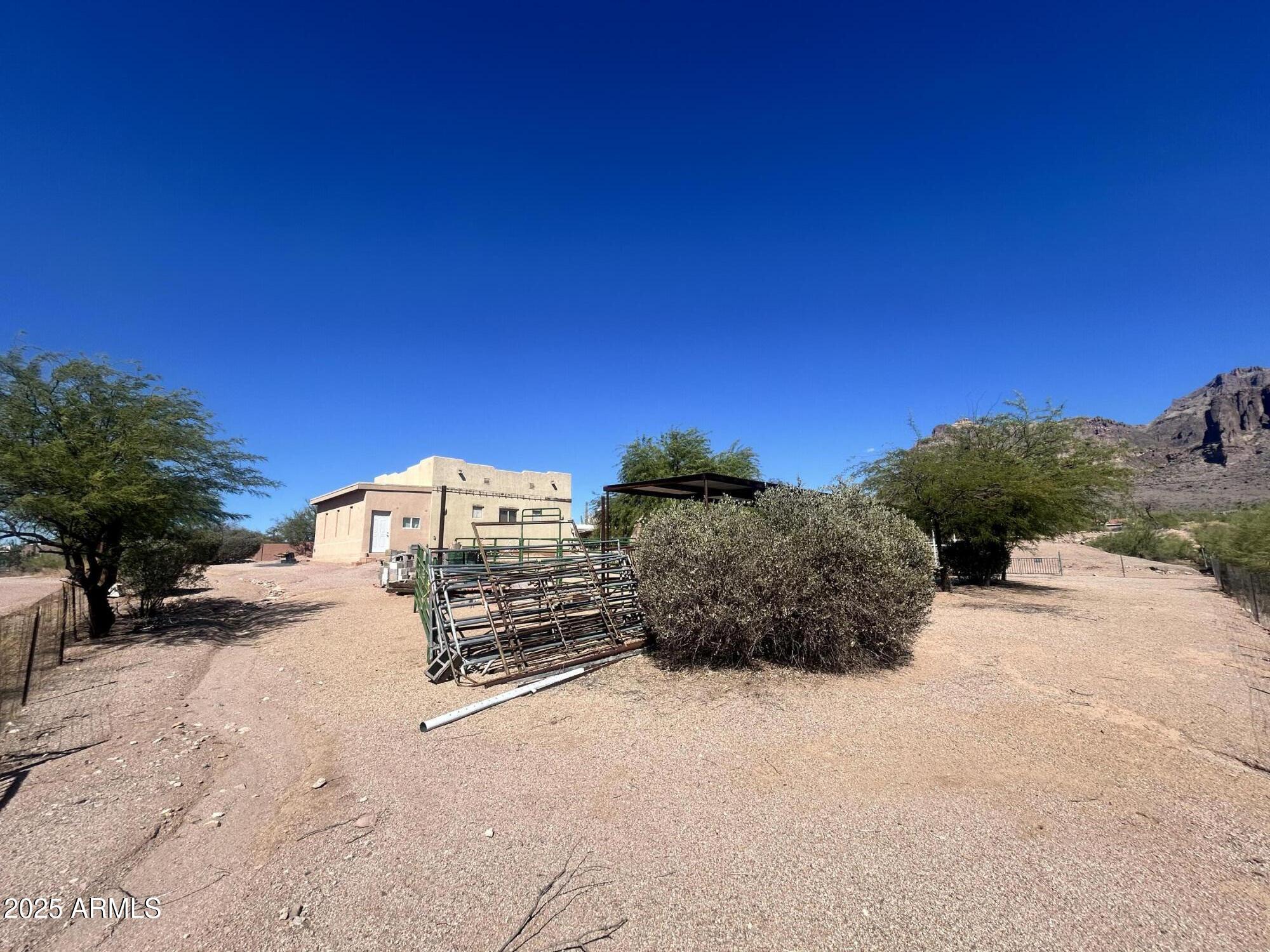 2950 North Val Vista Road Apache Junction, AZ 85119 - Photo 4 of 30 a view of a dry yard with a house in the background