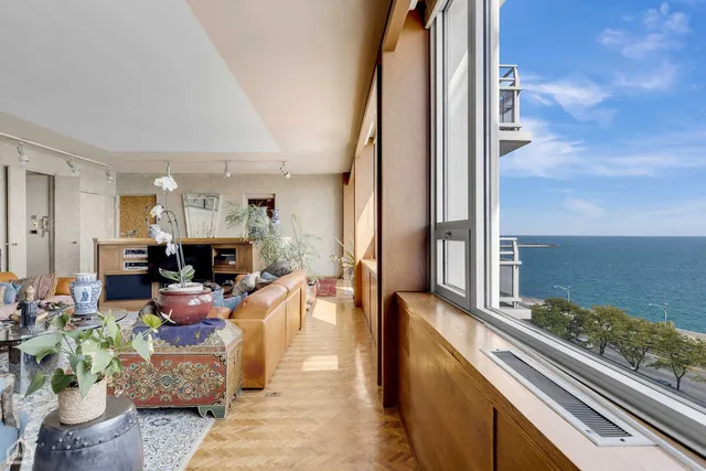 a living room with furniture and a floor to ceiling window
