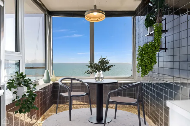 a view of a balcony with table and chairs