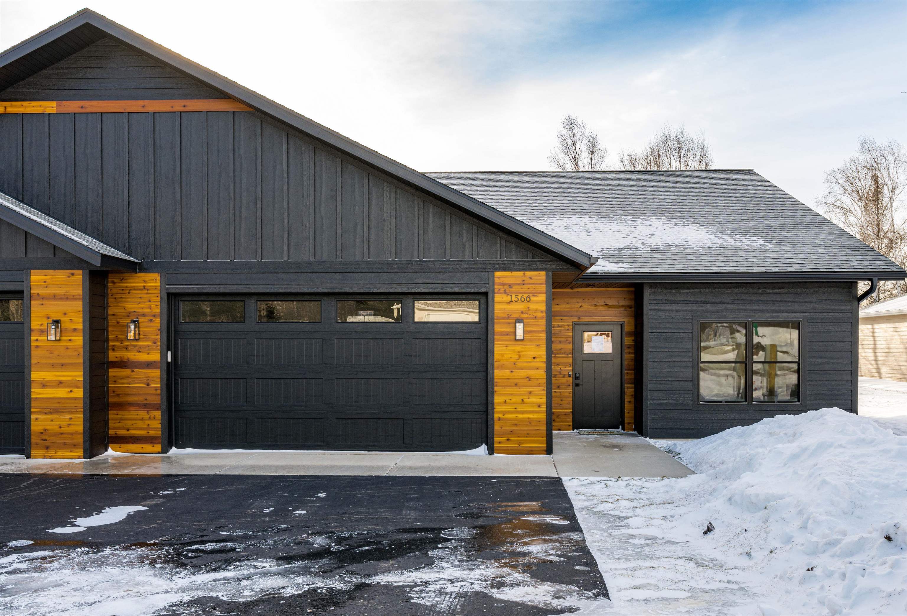 Contemporary home with roof with shingles and a garage