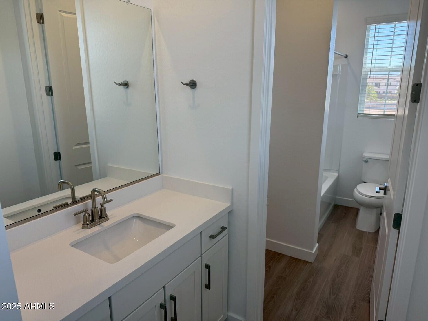 2443 West Rowel Road Phoenix, AZ 85085 - Photo 11 of 19 a bathroom with a sink toilet and a mirror