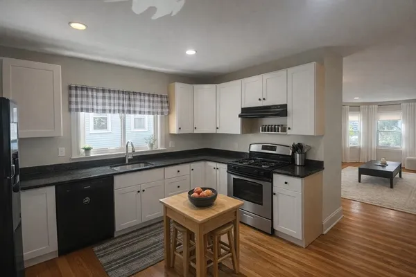 a kitchen with a stove a sink and a microwave