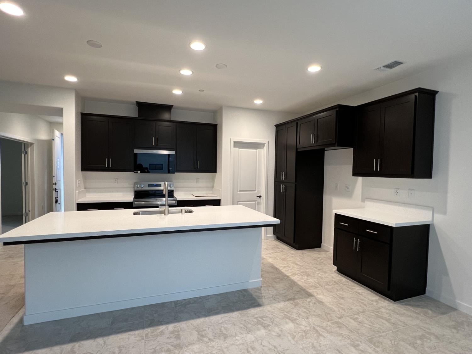 2628 Night Bloom Way Lathrop, CA 95330 - Photo 2 of 5 a kitchen with stainless steel appliances a stove microwave and refrigerator