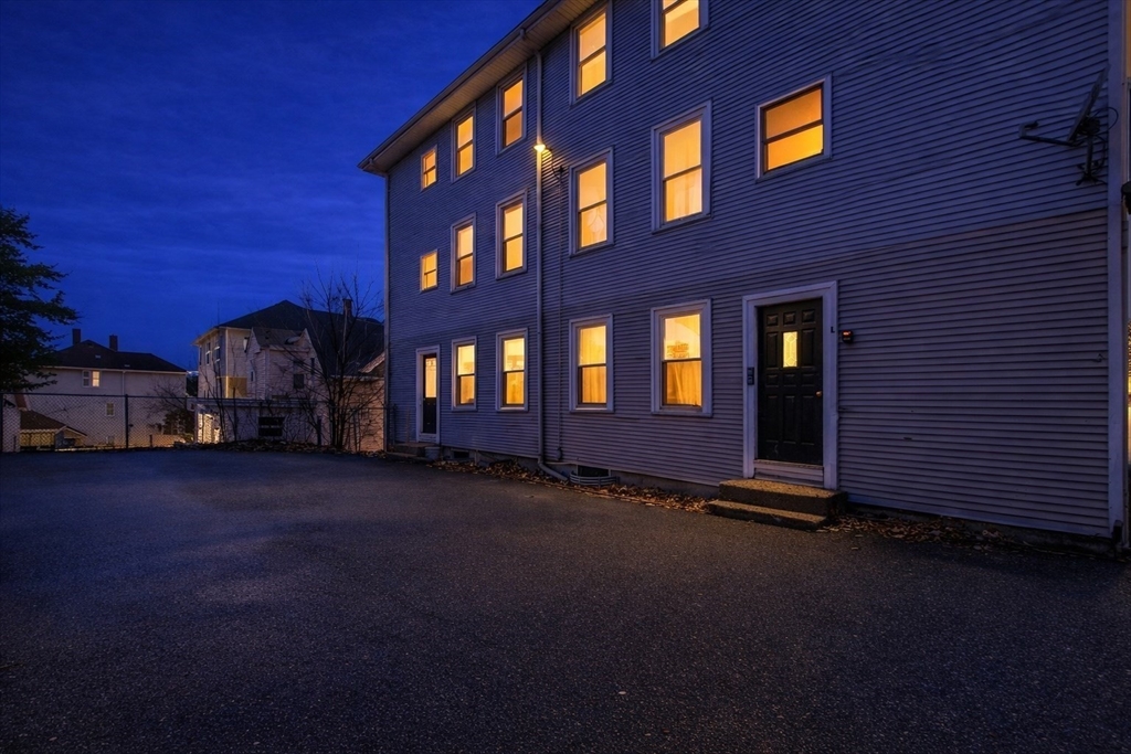 51 Wood Avenue Woonsocket, RI 02895 - Photo 11 of 14 a front view of a building with many windows and garden