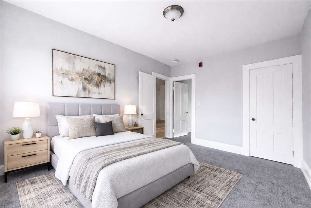 51 Wood Avenue Woonsocket, RI 02895 - Photo 4 of 14 a spacious bedroom with a bed and a view of bathroom