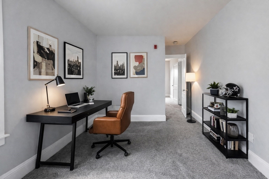 51 Wood Avenue Woonsocket, RI 02895 - Photo 5 of 14 a view of a workspace with lounge chair and a bookshelf
