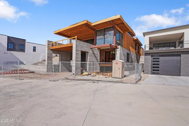 a front view of a house with a stove and a more tree