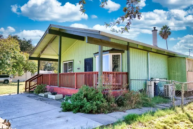 a view of a house with a flower garden