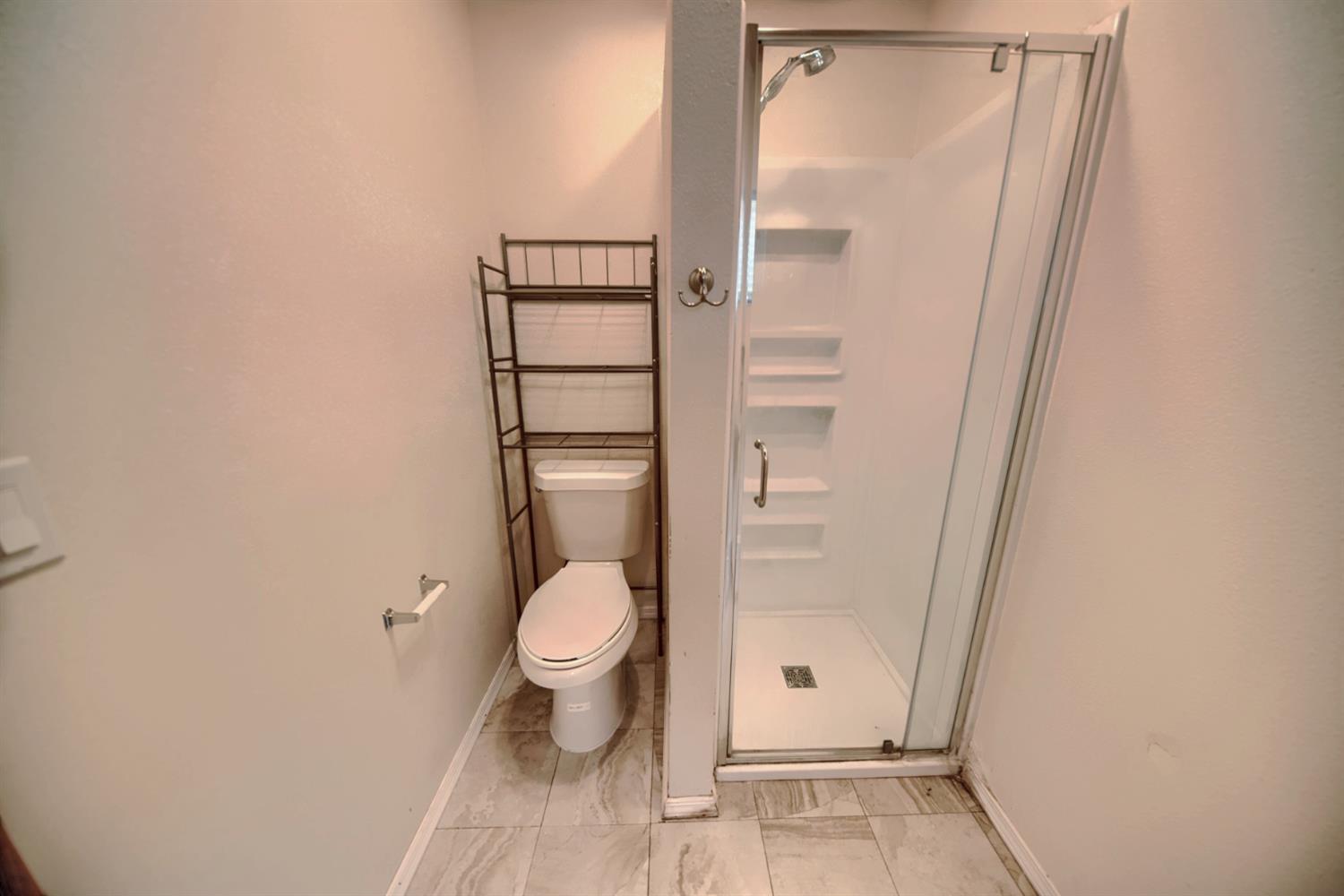 30000 Kasson Road Tracy, CA 95304 - Photo 58 of 71 a bathroom with a toilet and a shower
