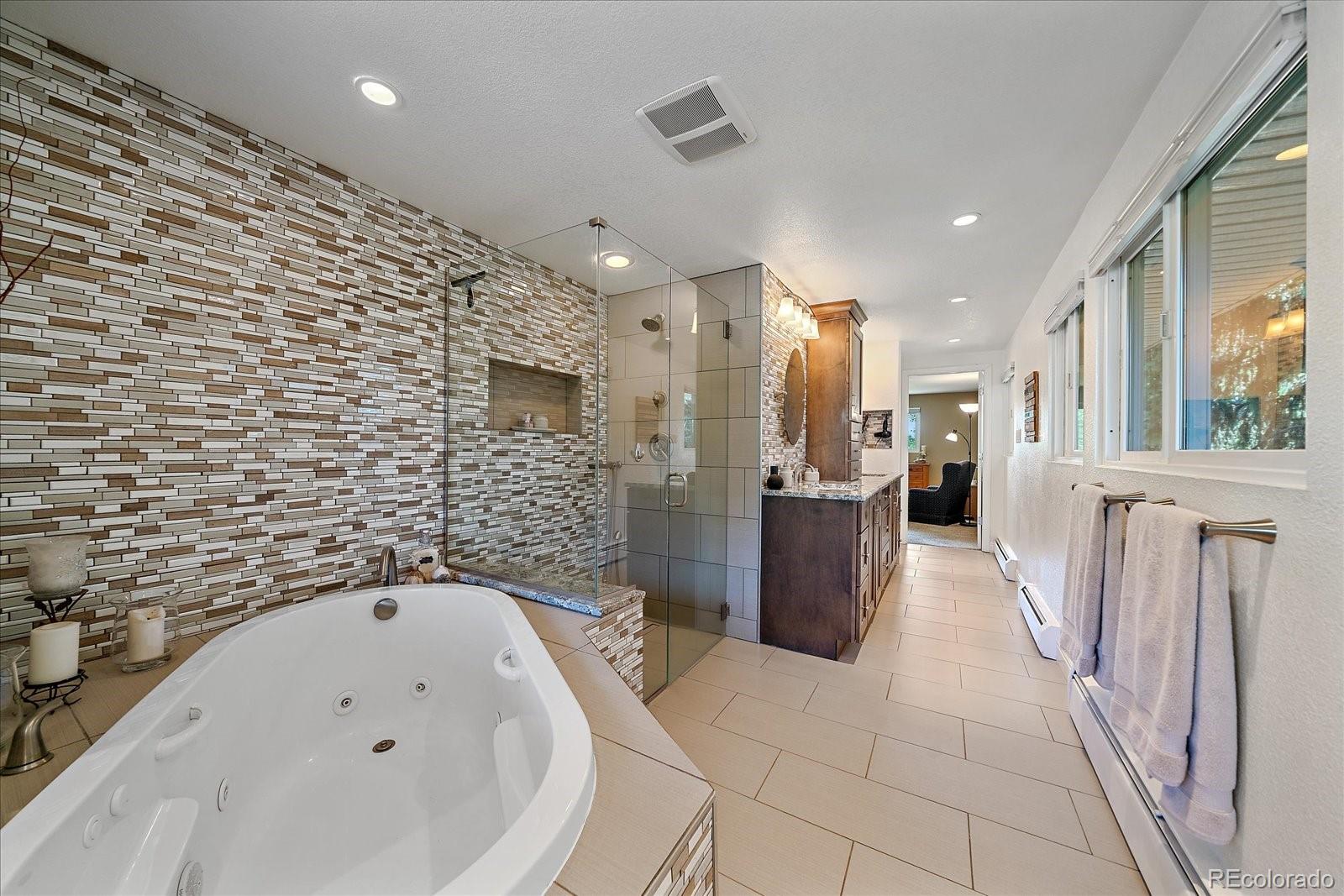 930 Reed Court Lakewood, CO 80214 - Photo 14 of 41 a bathroom with a bathtub and a shower