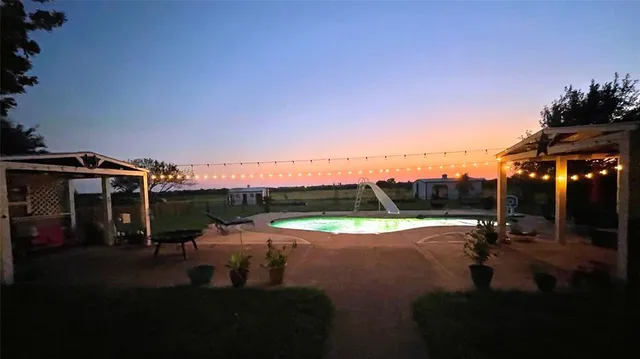 a front view of a house with a yard table and chairs