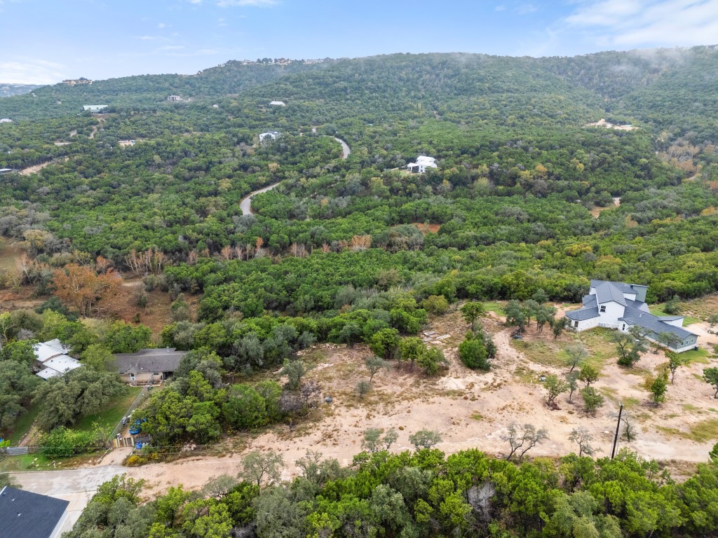 18211 Gregg Bluff Road Jonestown, TX 78645 - Photo 11 of 24 Drone / aerial view of a heavily wooded area