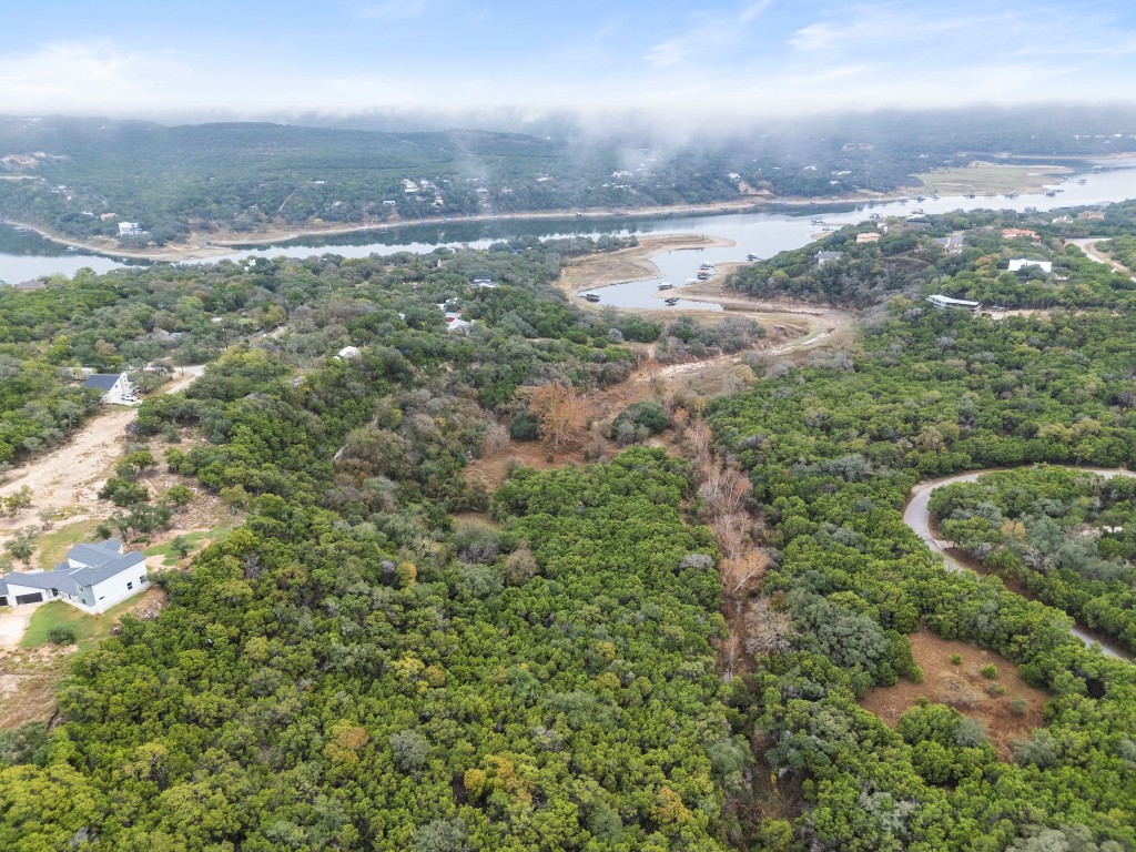 18211 Gregg Bluff Road Jonestown, TX 78645 - Photo 14 of 24 Drone / aerial view of a nearby body of water and a forest
