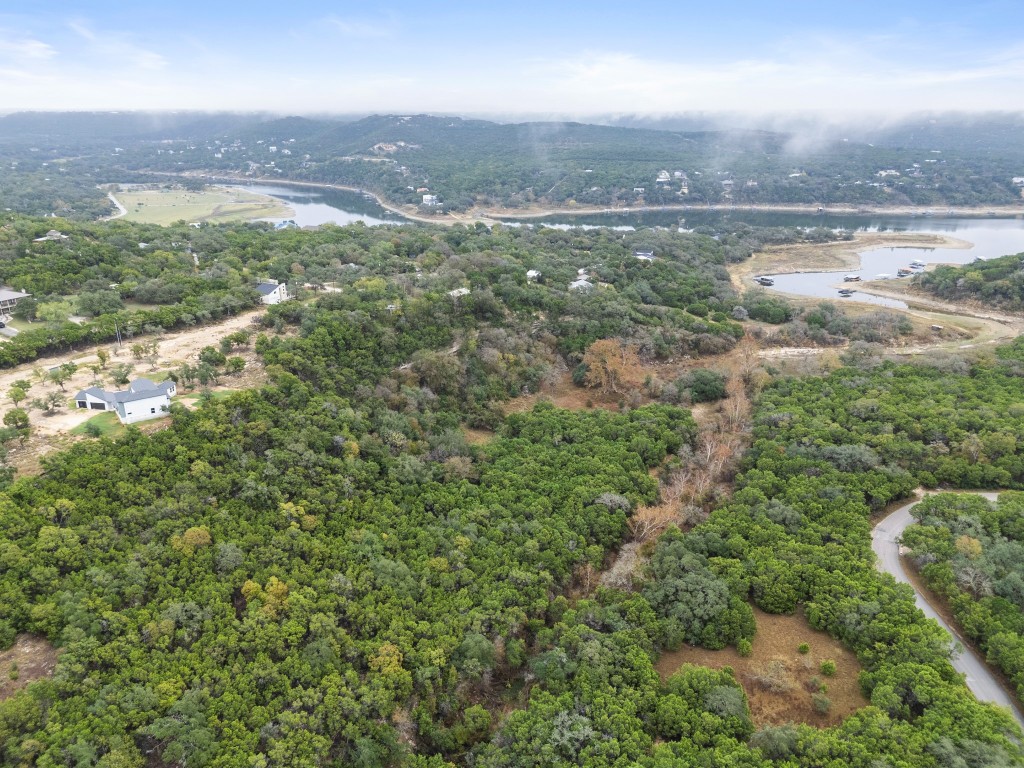 18211 Gregg Bluff Road Jonestown, TX 78645 - Photo 15 of 24 Aerial view of property's location with a large body of water and a heavily wooded area