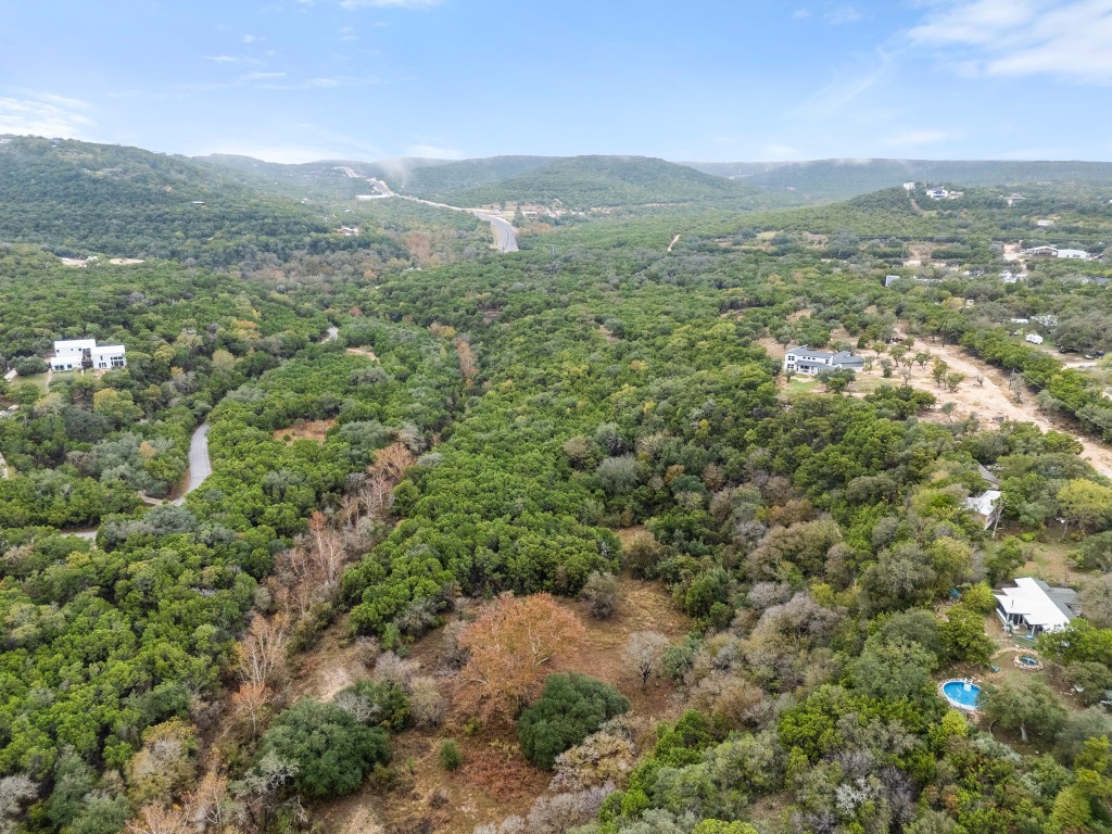 18211 Gregg Bluff Road Jonestown, TX 78645 - Photo 21 of 24 Aerial view of a mountainous background and a heavily wooded area