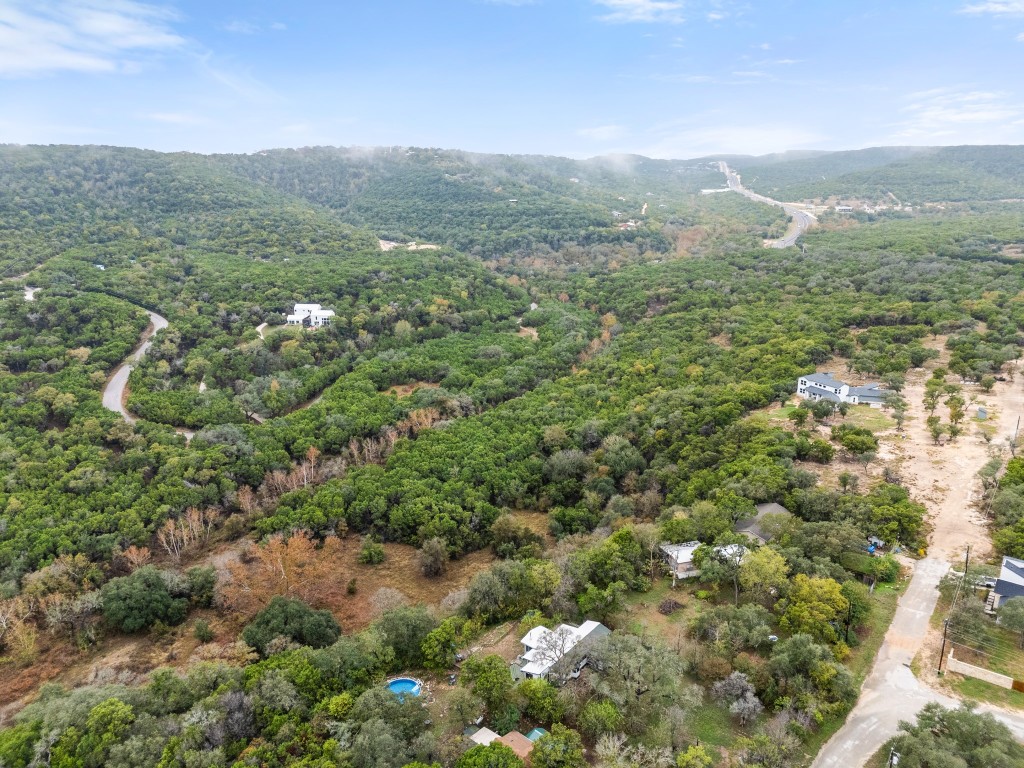 18211 Gregg Bluff Road Jonestown, TX 78645 - Photo 22 of 24 Drone / aerial view of a forest and a mountain backdrop