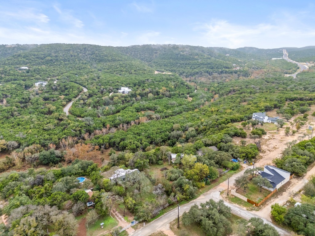 18211 Gregg Bluff Road Jonestown, TX 78645 - Photo 23 of 24 Drone / aerial view of a heavily wooded area and a mountainous background