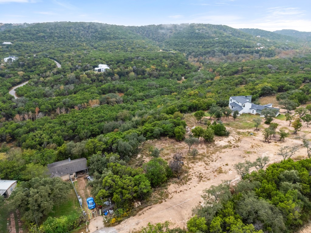 18211 Gregg Bluff Road Jonestown, TX 78645 - Photo 10 of 24 Bird's eye view of a forest and a mountain backdrop